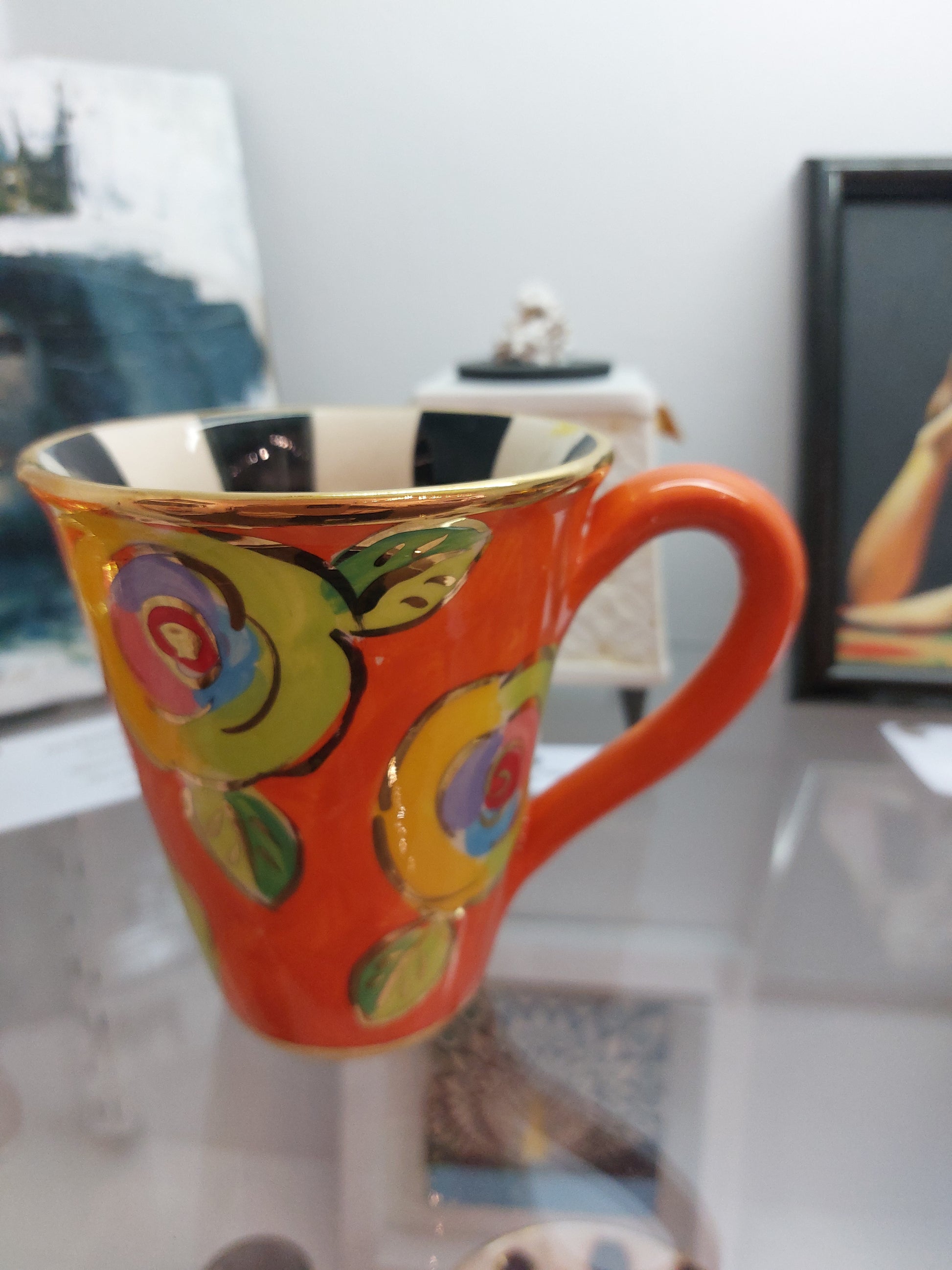 Orange Mug with Yellow and Green Roses. Gold highlights with Black and White Stripe Inside.