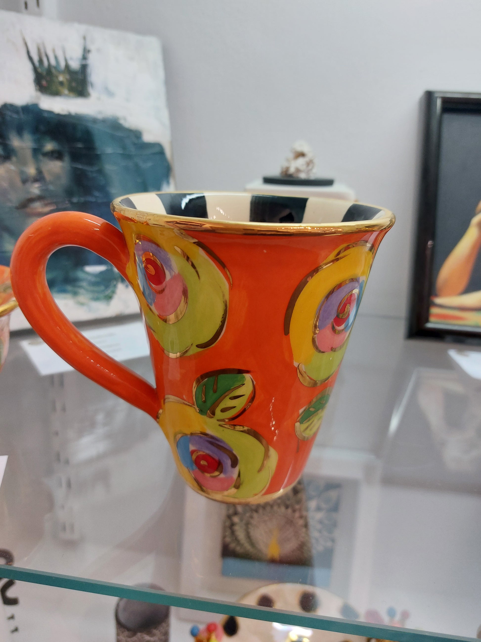 Orange Mug with Yellow and Green Roses. Gold highlights with Black and White Stripe Inside.